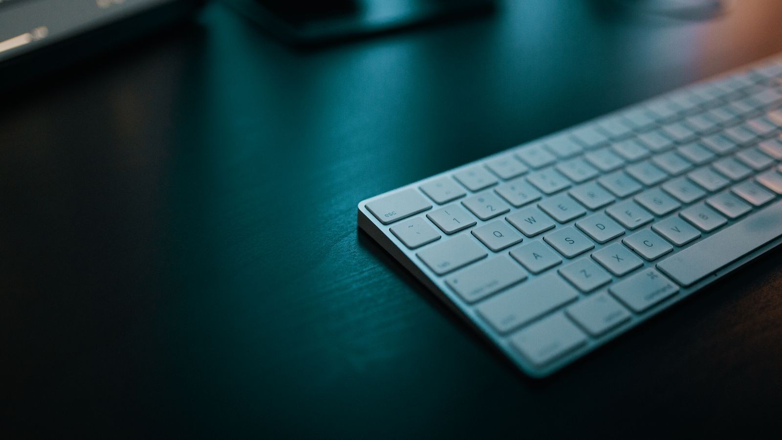 Writer's hands resting on a palm support while using an ergonomic keyboard and mouse setup