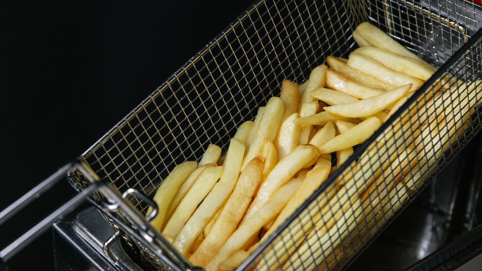 Family kitchen counter with a large air fryer and fresh cooked vegetables ready to serve
