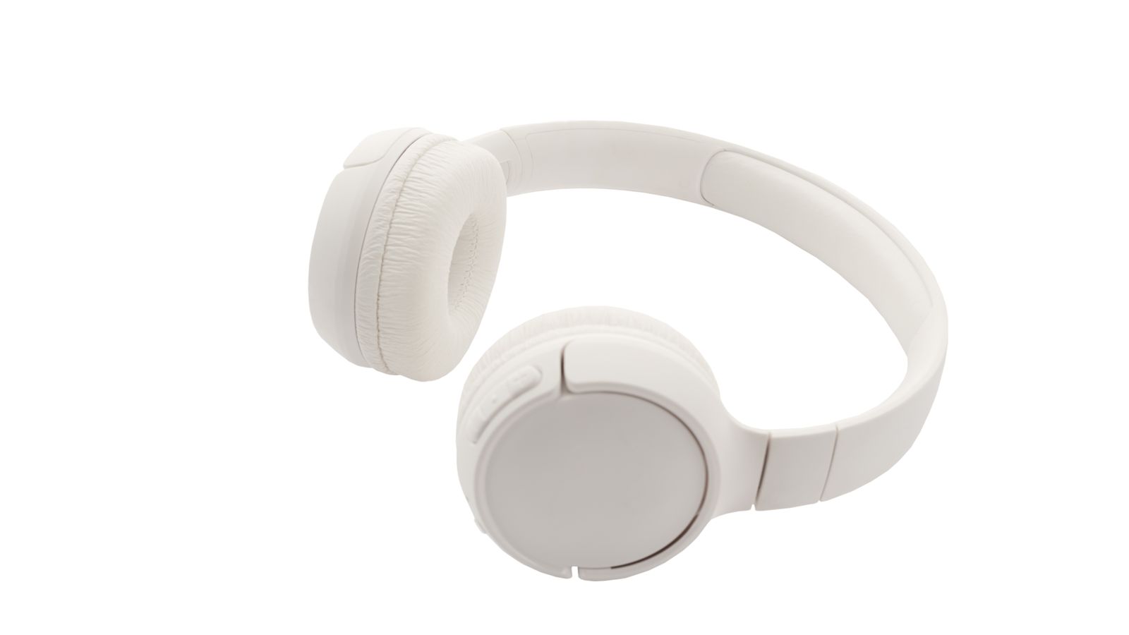 Headphones hanging neatly from a desk-mounted headset hanger next to a keyboard
