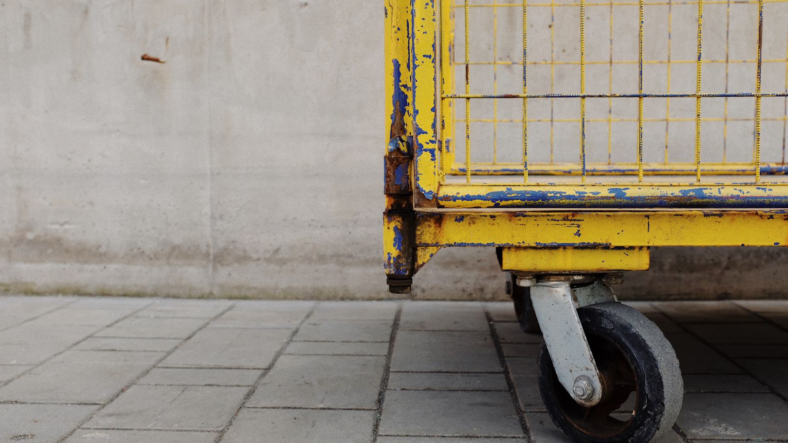 Rolling utility cart placed beside a home office desk for extra storage