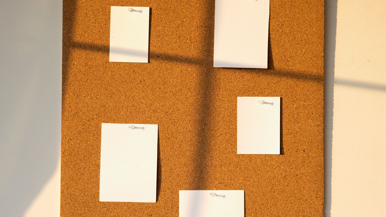 Modern office corner combining a wall bulletin board and window treatment for light control
