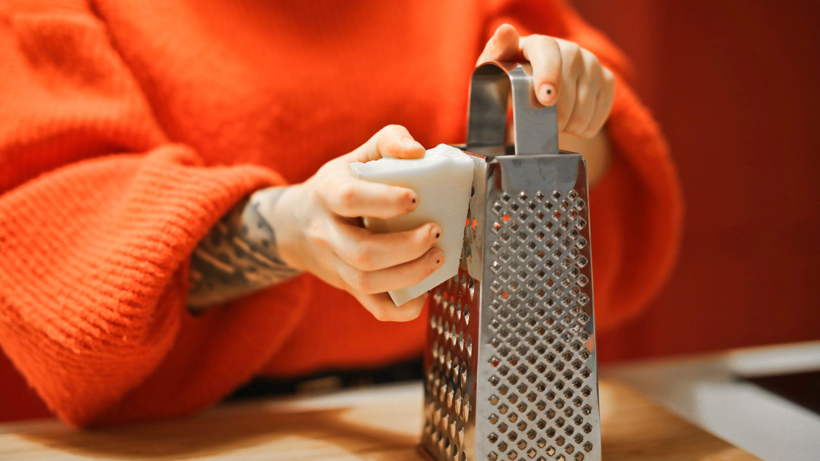 Person applying shredder oil to the blades of a cross cut paper shredder for maintenance