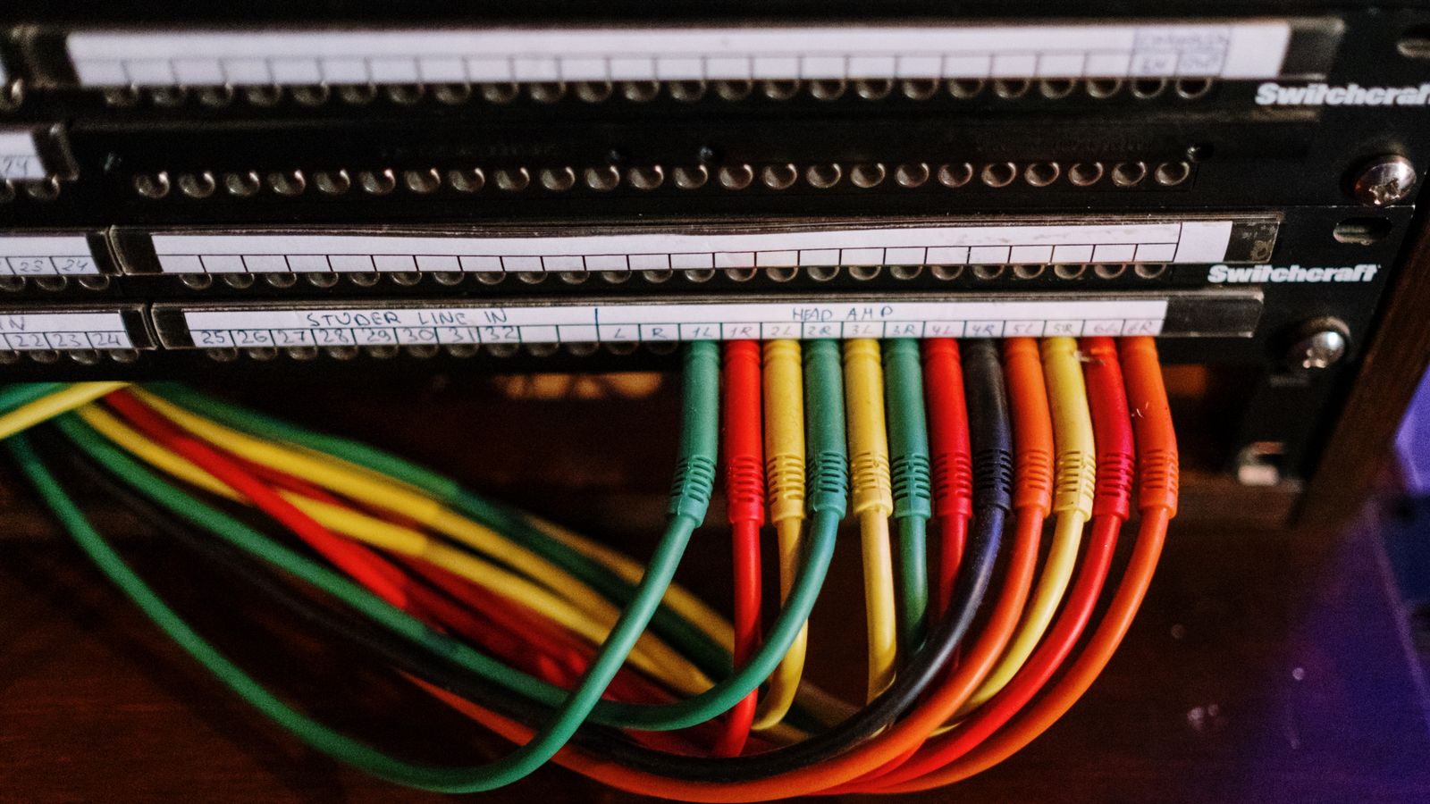 Cables neatly routed and hung under a cubicle desk using hooks