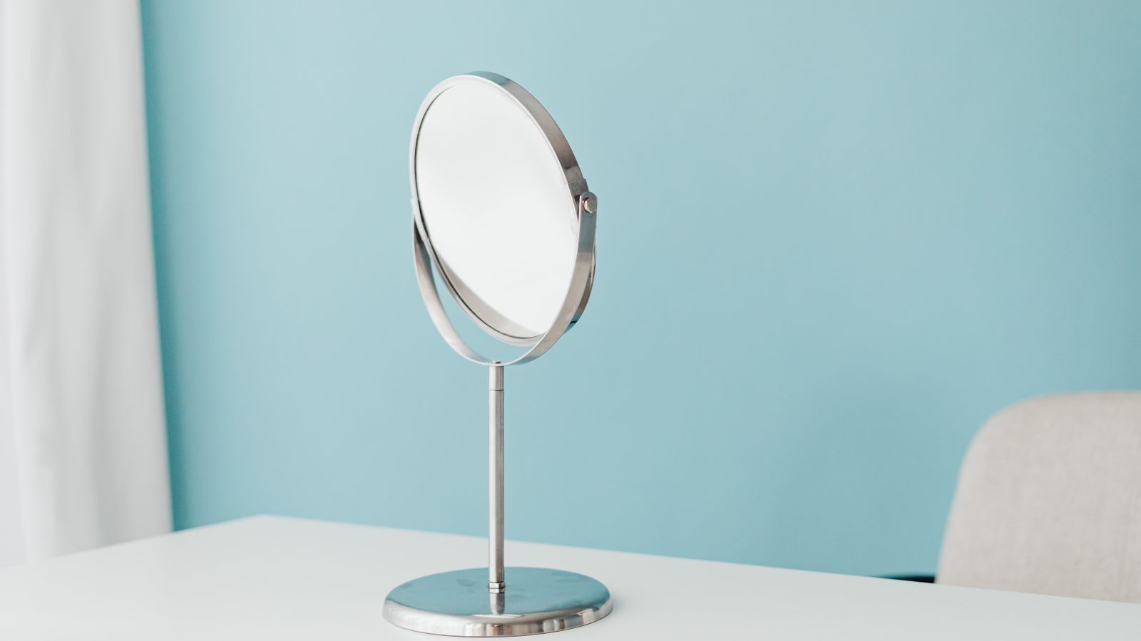 Desk mirror clip mounted on a monitor edge in a tidy home office setup