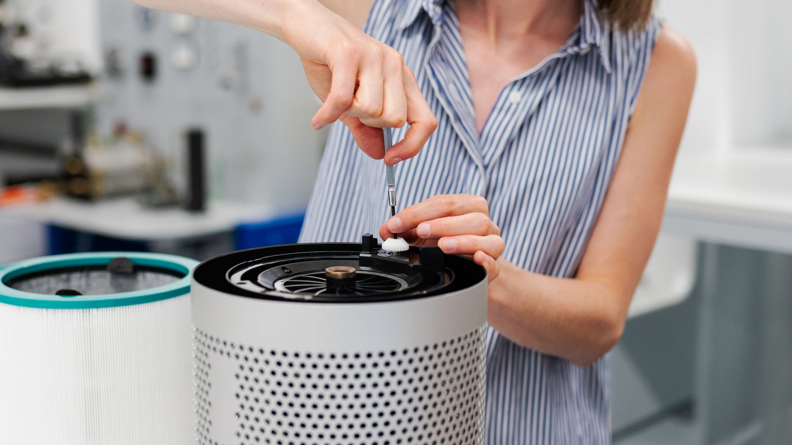 Close-up of a used air purifier filter being removed for inspection