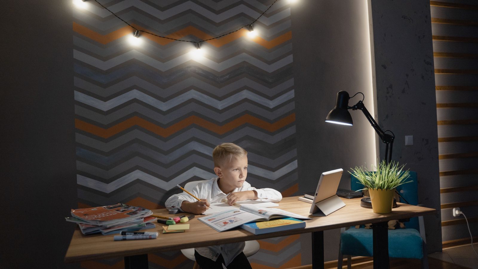 Small family workspace with a compact kids desk and organized storage in a shared room