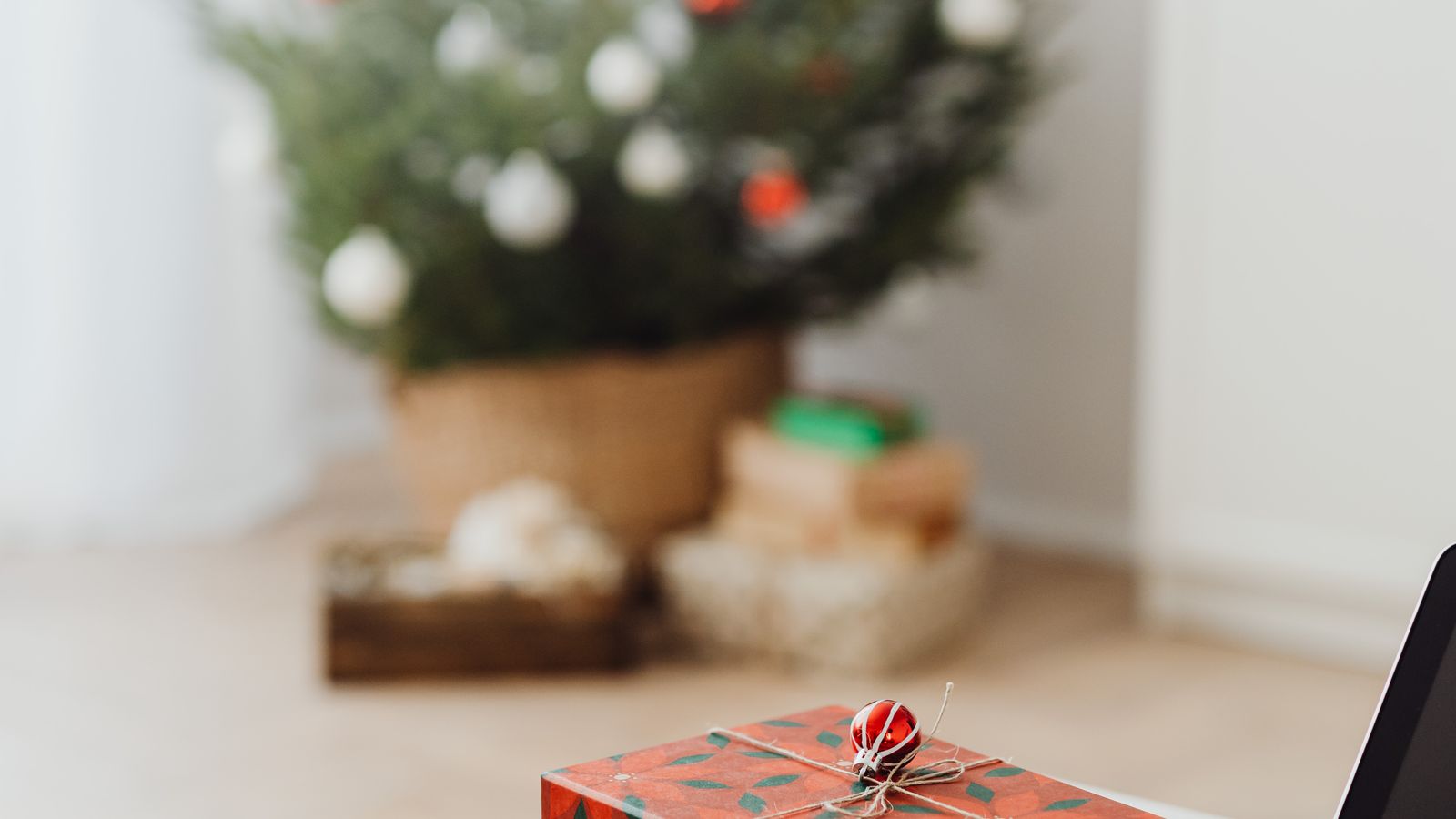 Gift box being packed with a desk footrest and other ergonomic office accessories