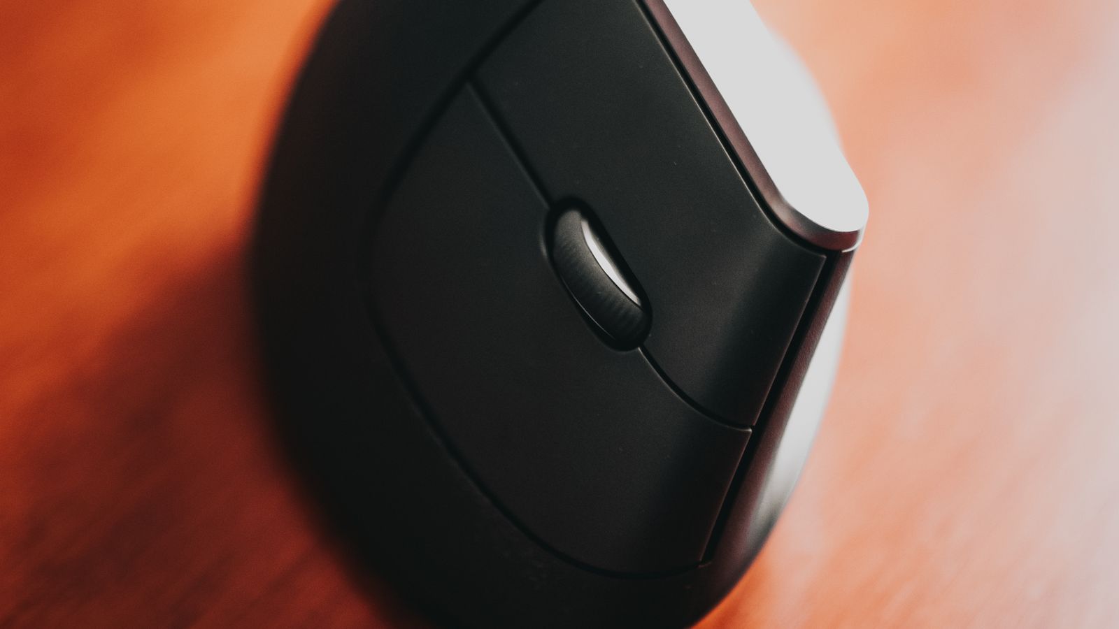 Roller bar mouse mounted beneath a keyboard tray for centered, neutral wrist use