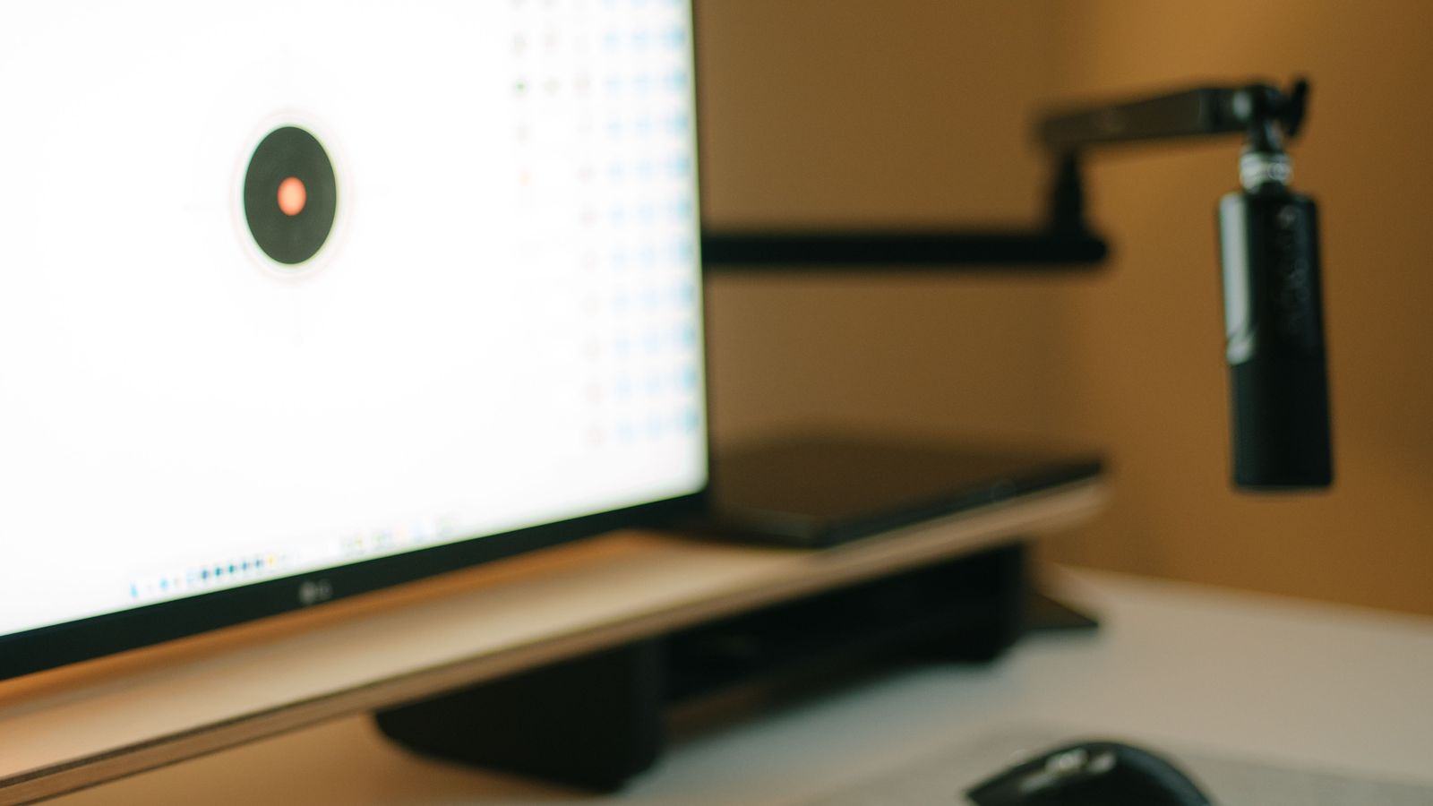 Monitor arm mounted on a standing desk with a dual-monitor setup