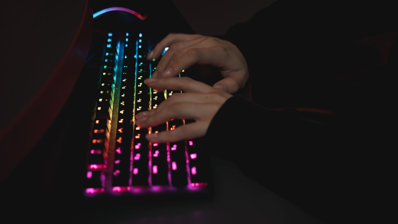 Close-up of worn keycaps and split ergonomic keyboard hinge showing signs of wear