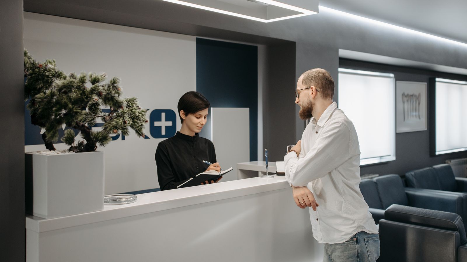 Modern reception desk in a bright office lobby showing daily wear points