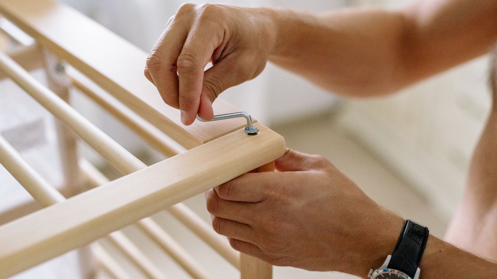 Close-up of Allen wrench tightening a bolt during office chair hardware maintenance