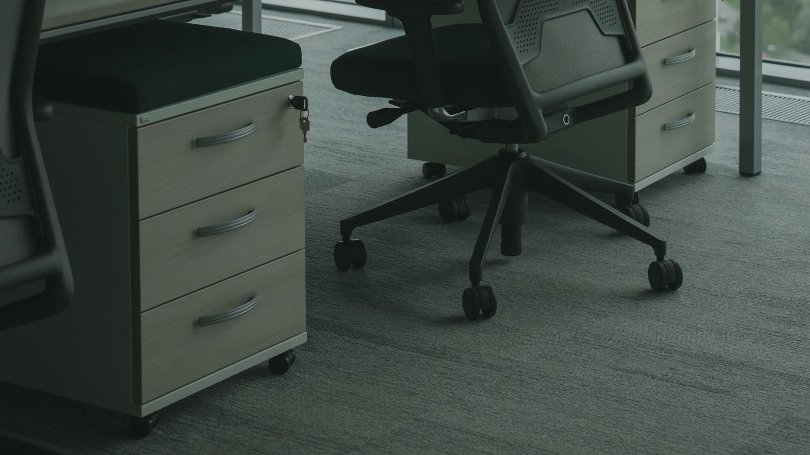 Office chair seat and base hardware being checked for wear before replacement