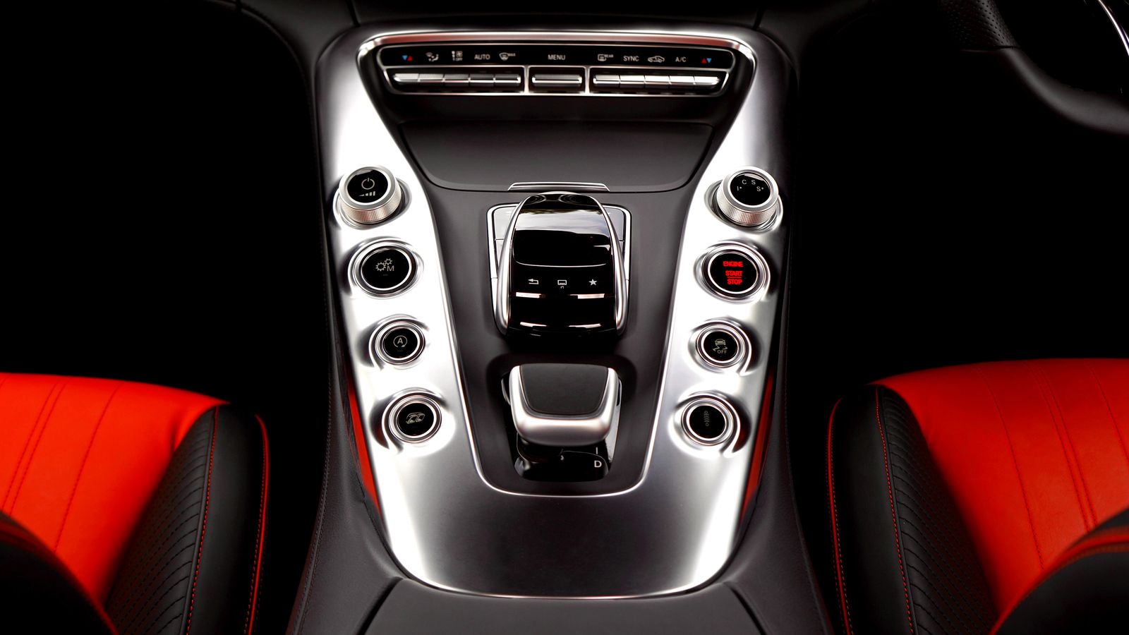 Driver reaching toward a car console area with multiple accessories installed near the dashboard