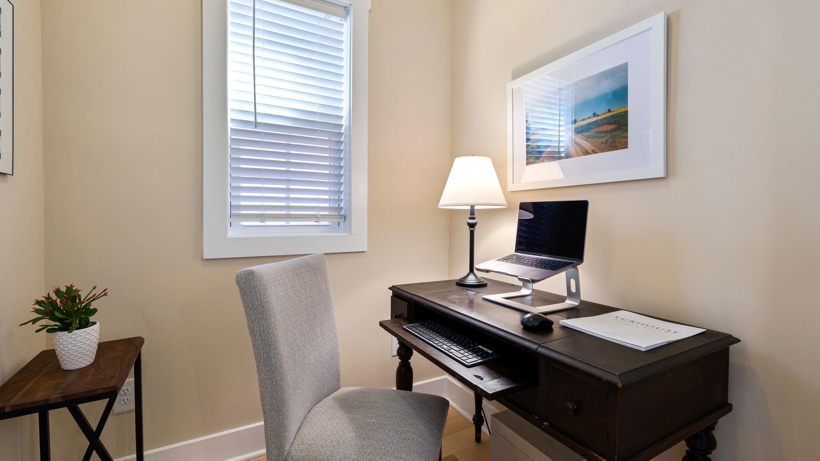 Wooden desk with vertical wall shelving used for compact home office storage
