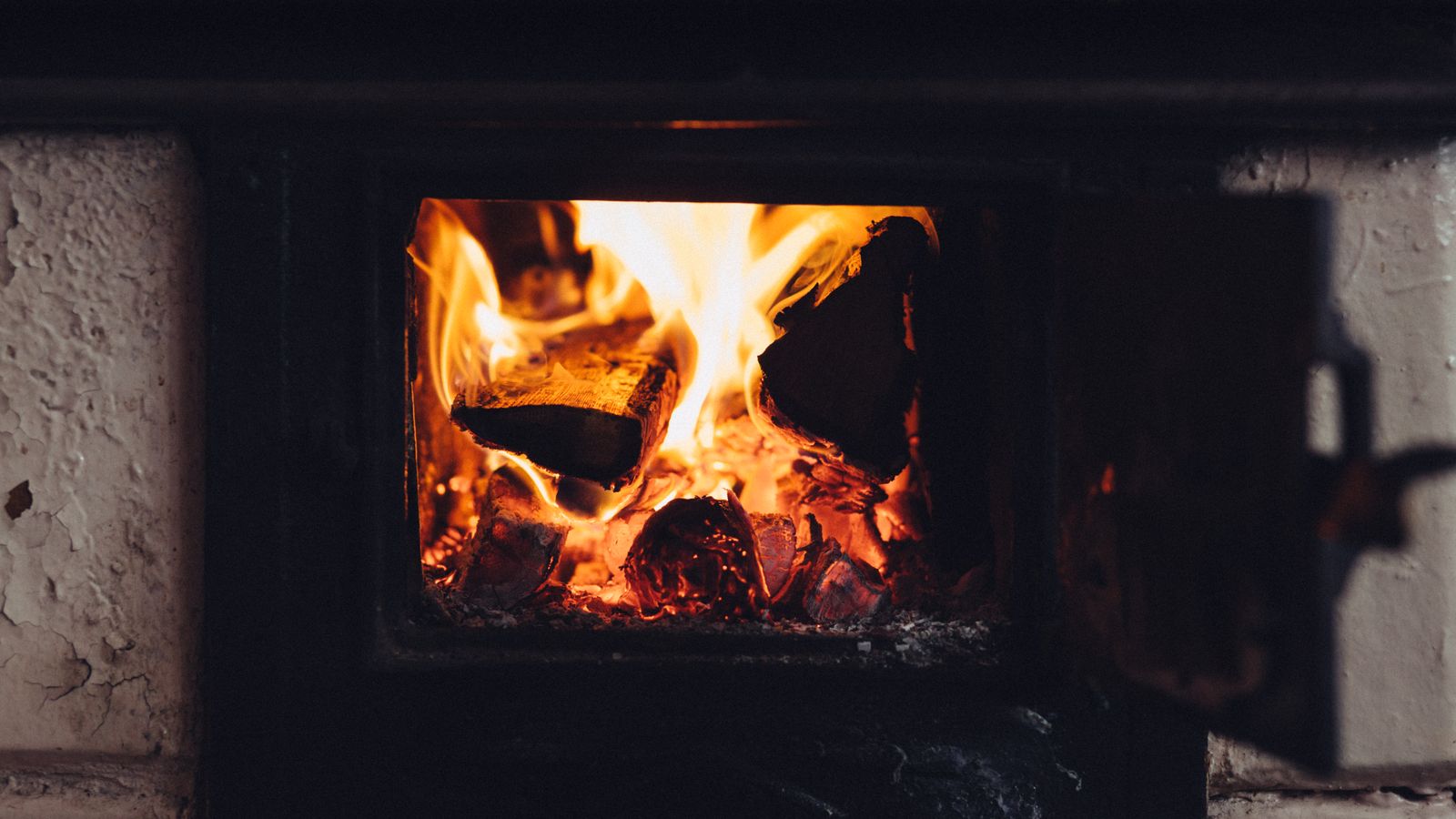 Wood burning stove glowing in a cozy living room as part of a home comfort gift bundle