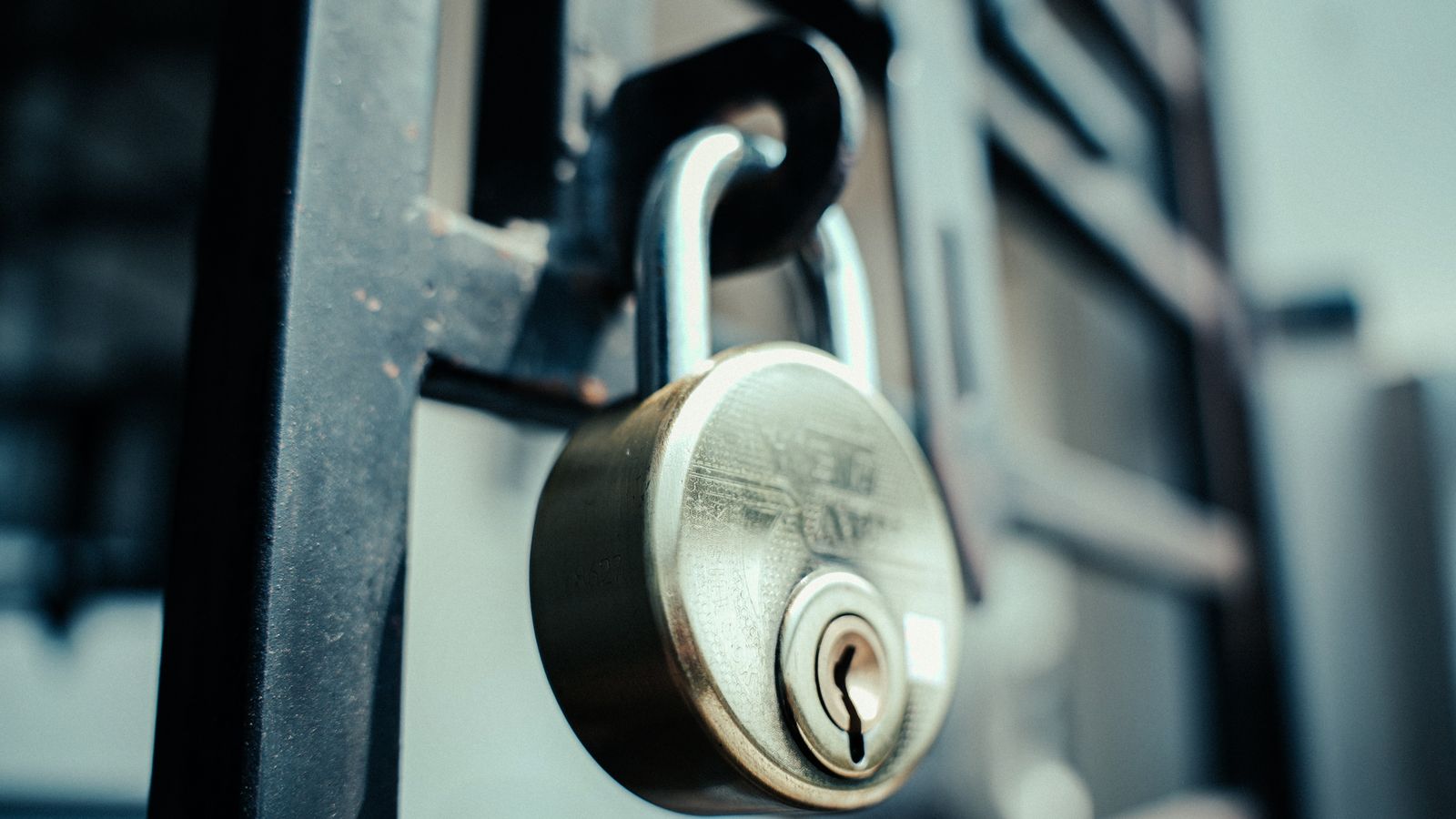 Close-up of a secure padlock and latch representing home security hardware maintenance