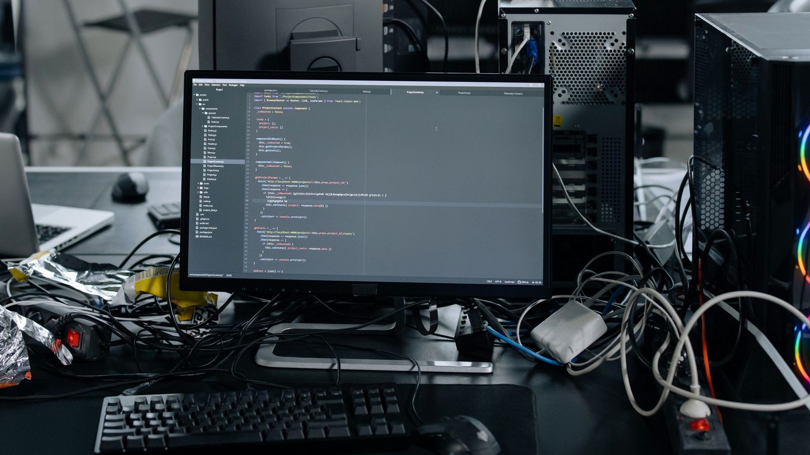 Organized home office desk setup with cable management near a computer tower stand