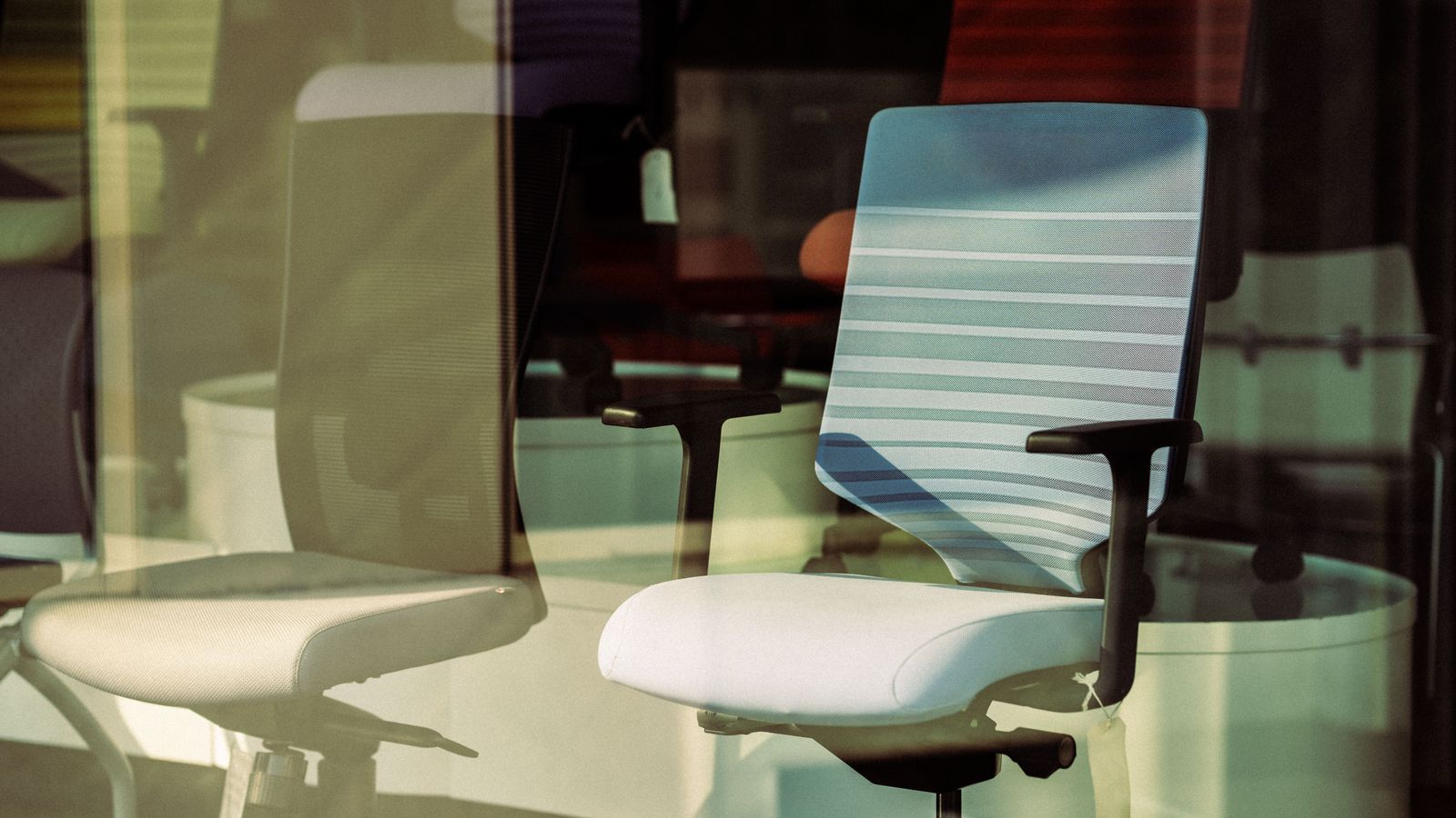 Person adjusting lumbar back support attached to an office chair