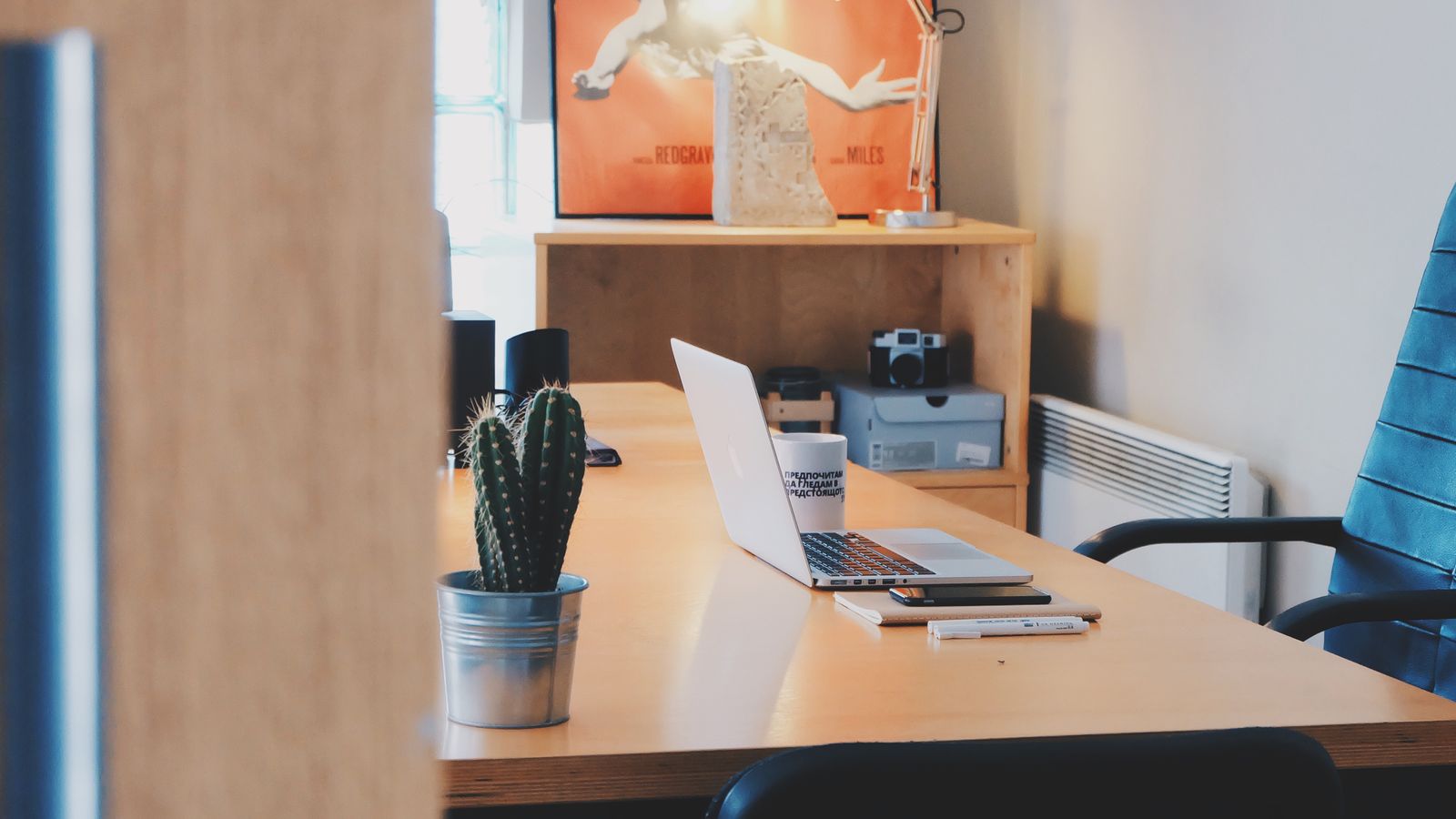 Modern low-profile desk setup with laptop in a contemporary home office