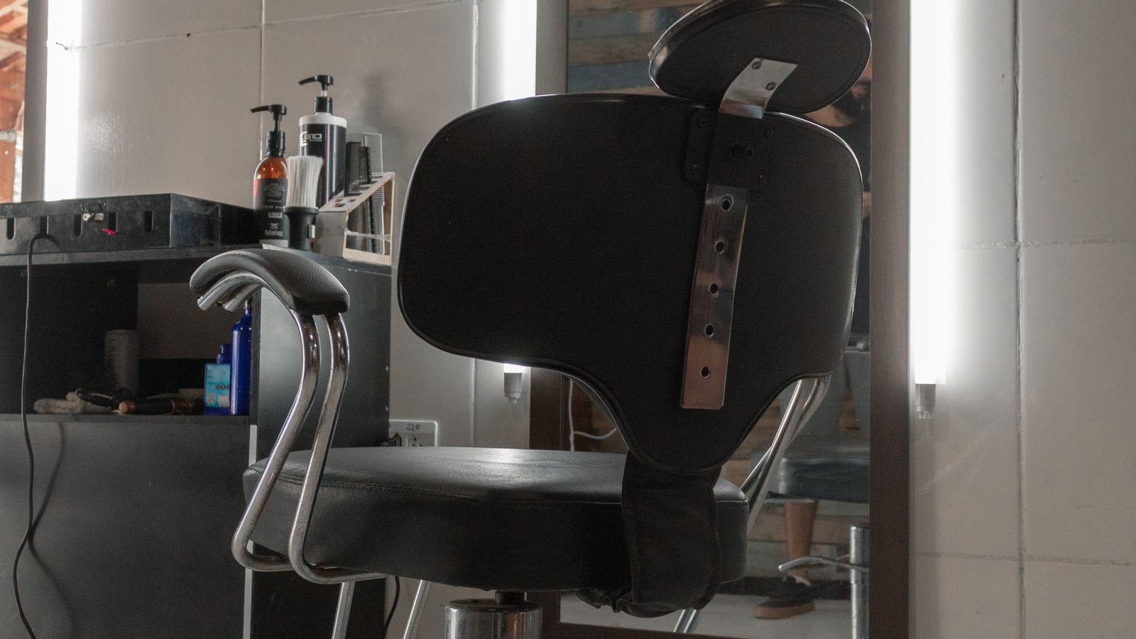 Detached office chair headrest resting on a desk before storage