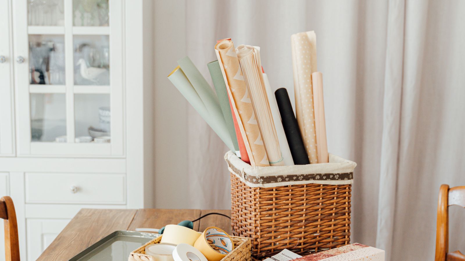 Craft table wrapped in protective blanket and leaned against a wall for storage
