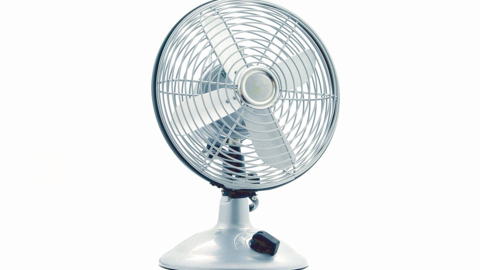 A small desk fan sitting on an office table ready to be cleaned before storage