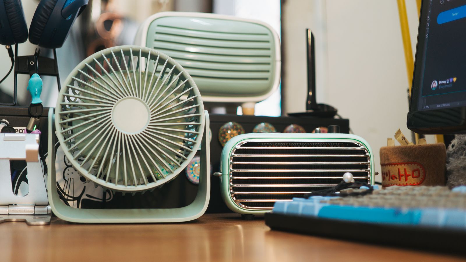 A cleaned office fan with cord neatly coiled next to a storage box