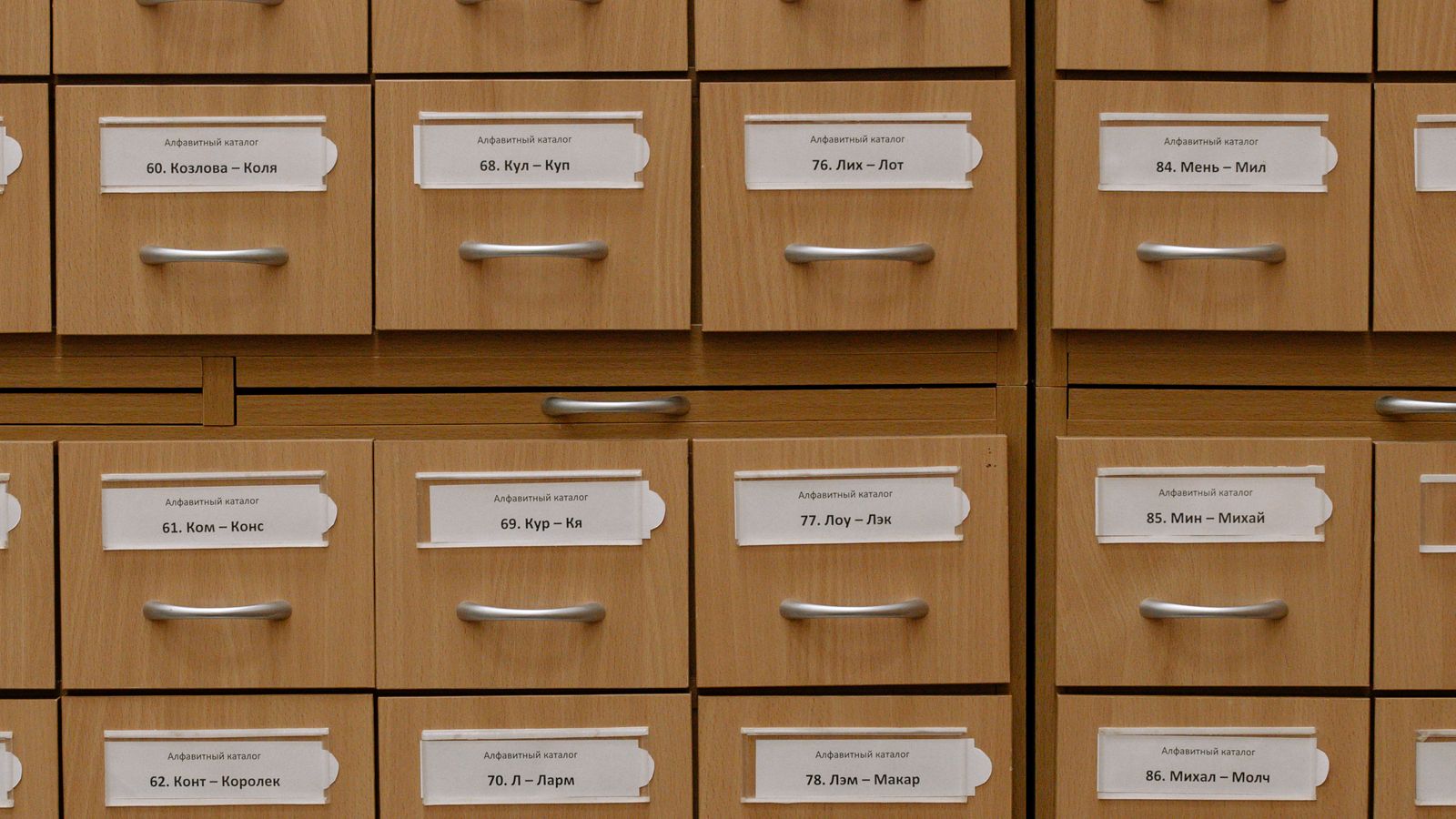 Close-up of hanging file folders installed on rails inside a lateral file cabinet drawer