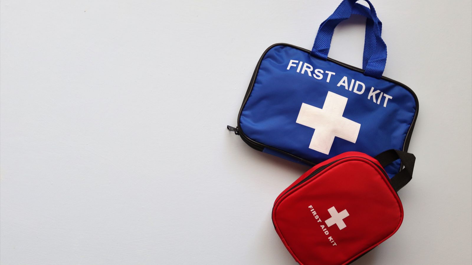 Office first aid kit and portable space heater arranged together on a desk