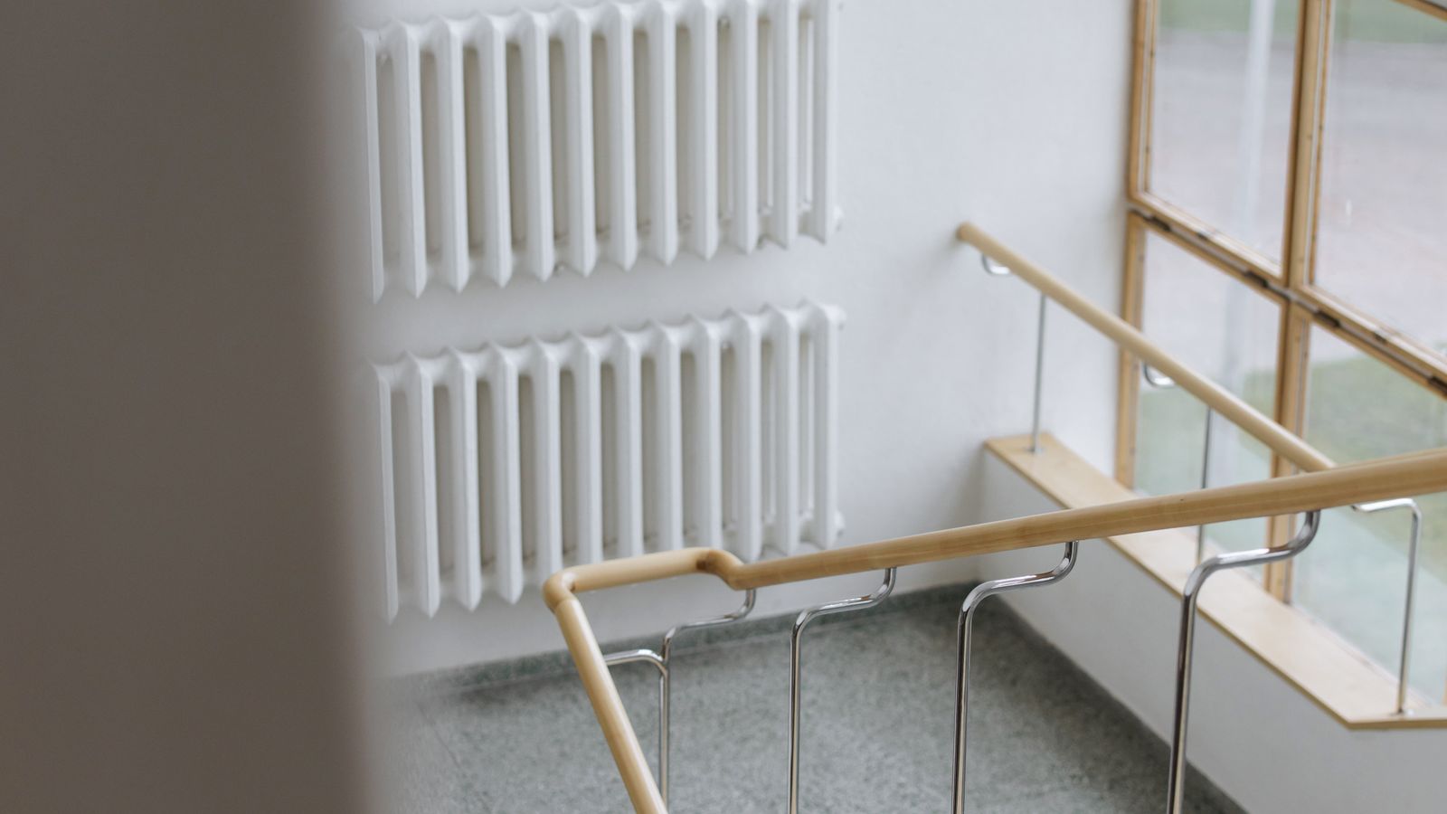 Compact ceramic space heater with visible safety cord placed near an office desk