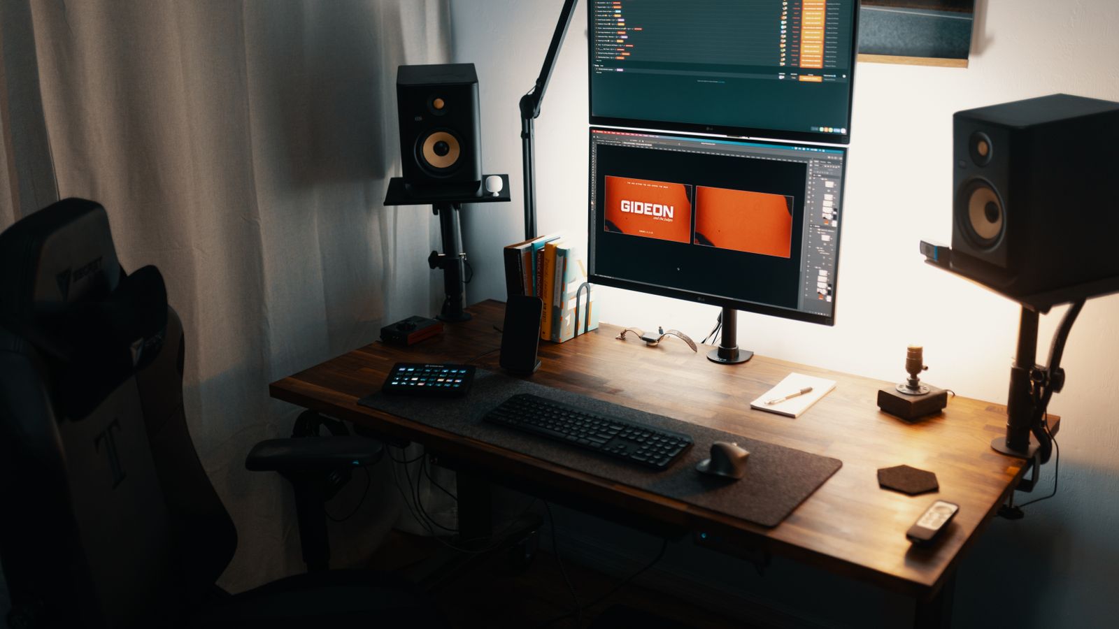Adjustable desk riser holding two monitors above a keyboard tray