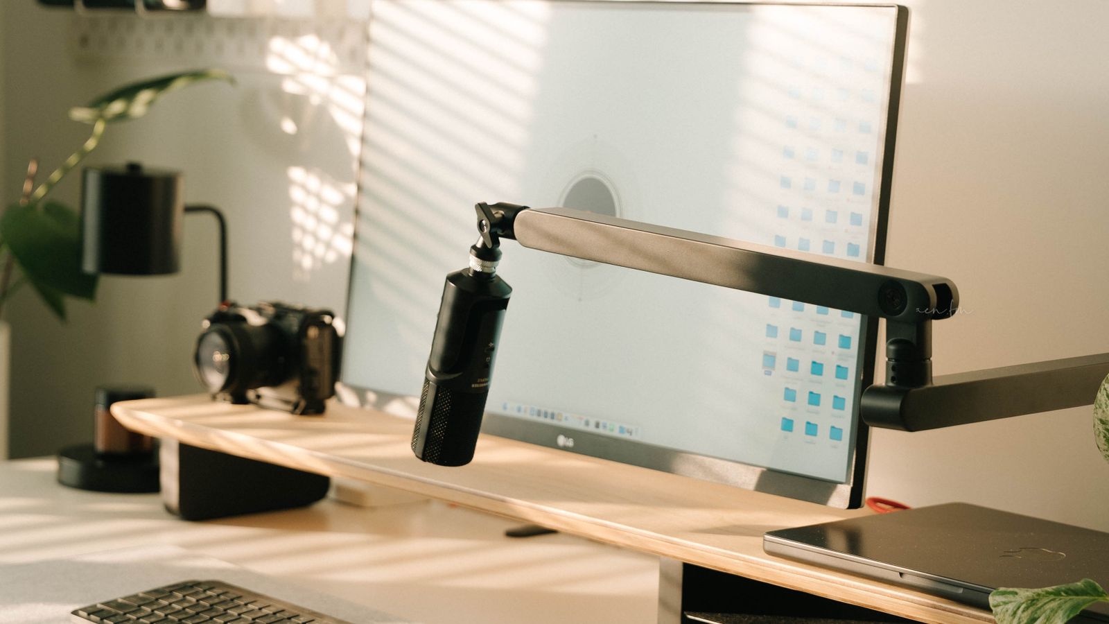 Minimalist creative workspace desk with microphone and clean cable management