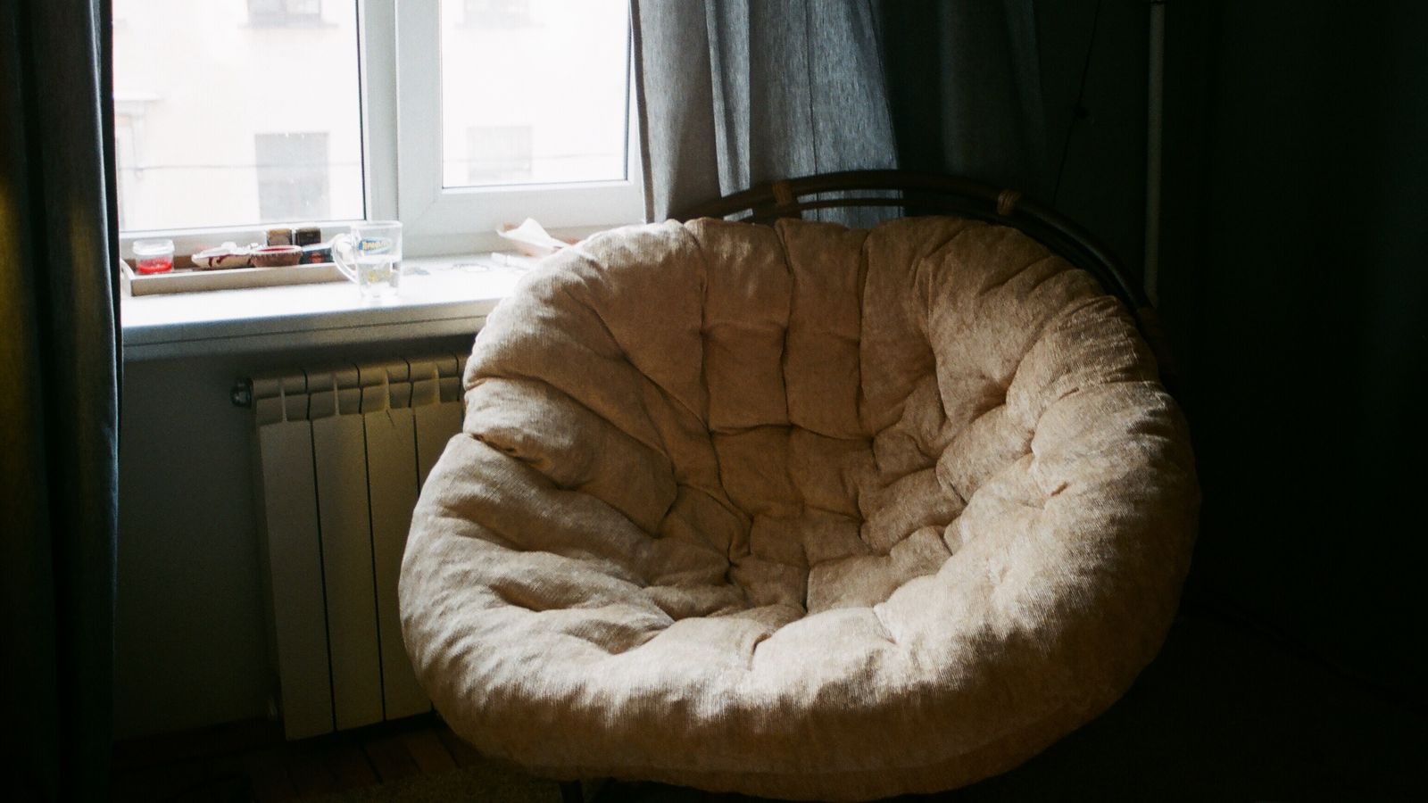 Coccyx cutout cushion positioned on an office chair seat to relieve tailbone pressure