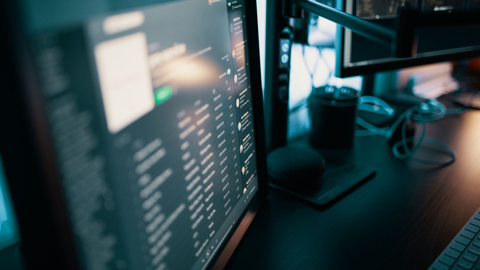 Cable management sleeve routing HDMI and USB-C cables along a monitor arm