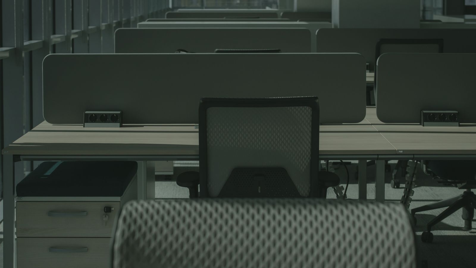 Close-up of a breathable mesh office chair seat and frame in a bright room