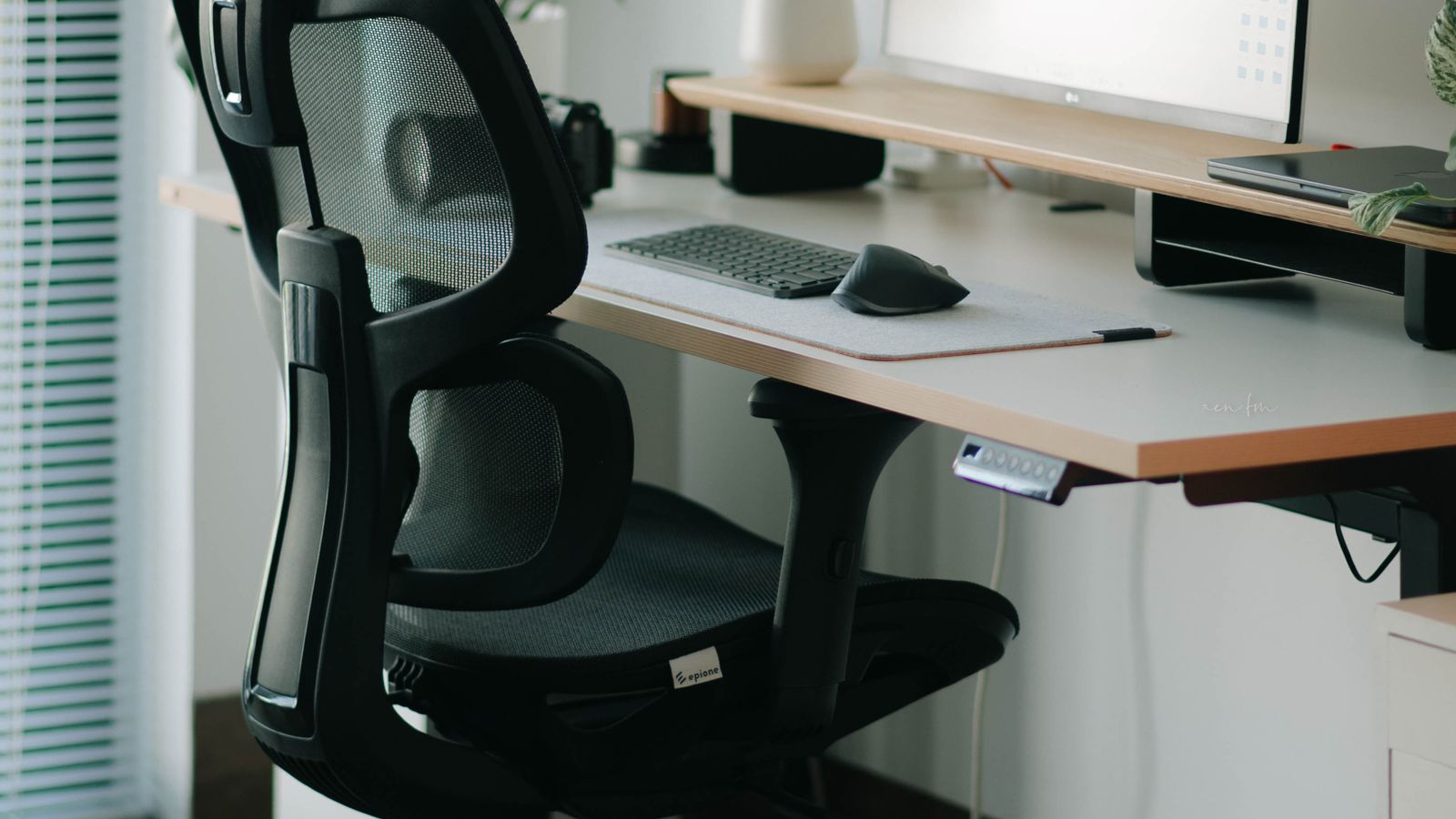 Person adjusting the lumbar support dial on a high-end ergonomic office chair