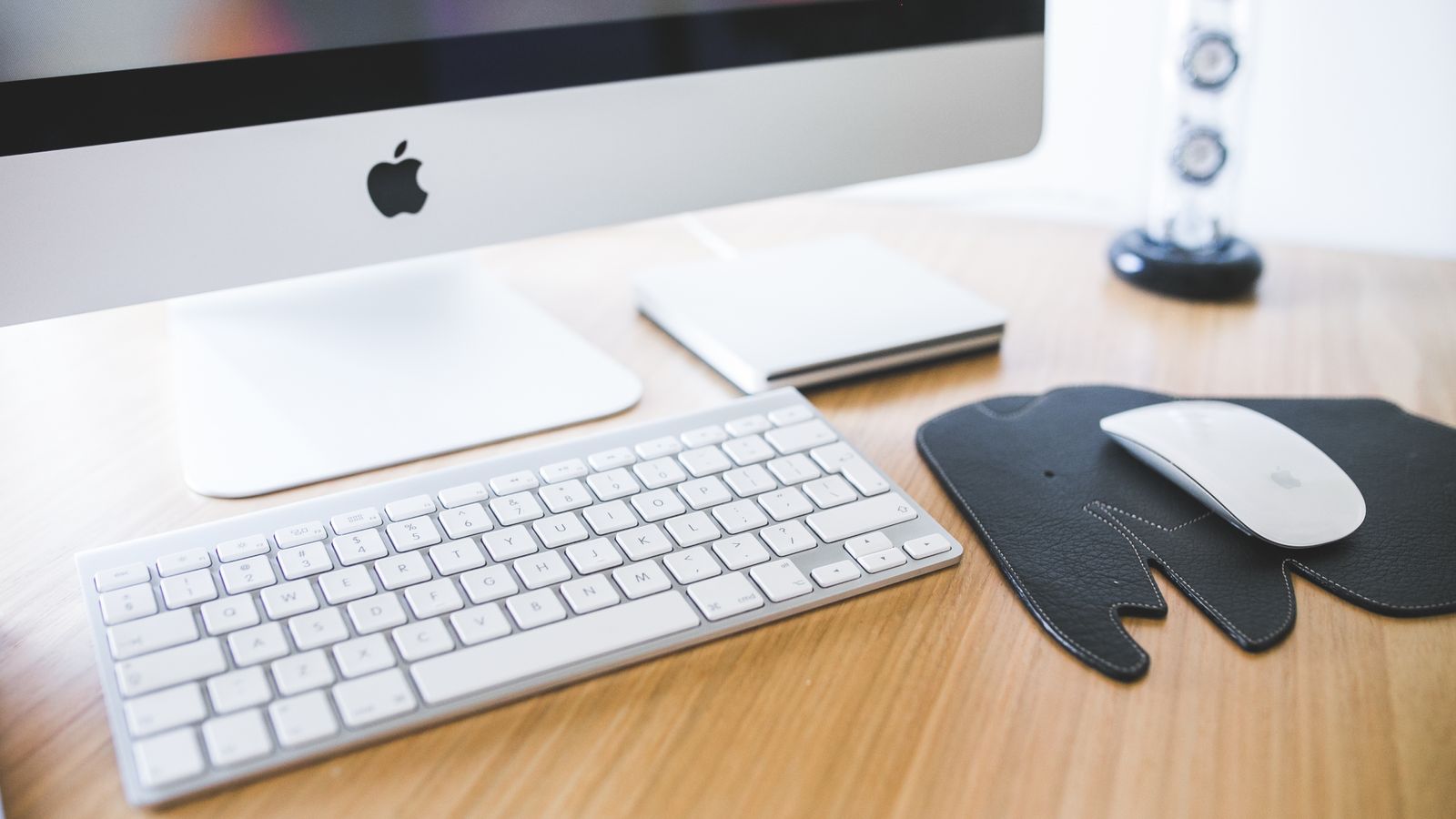 Organized desk setup with a wireless ergonomic keyboard and mouse