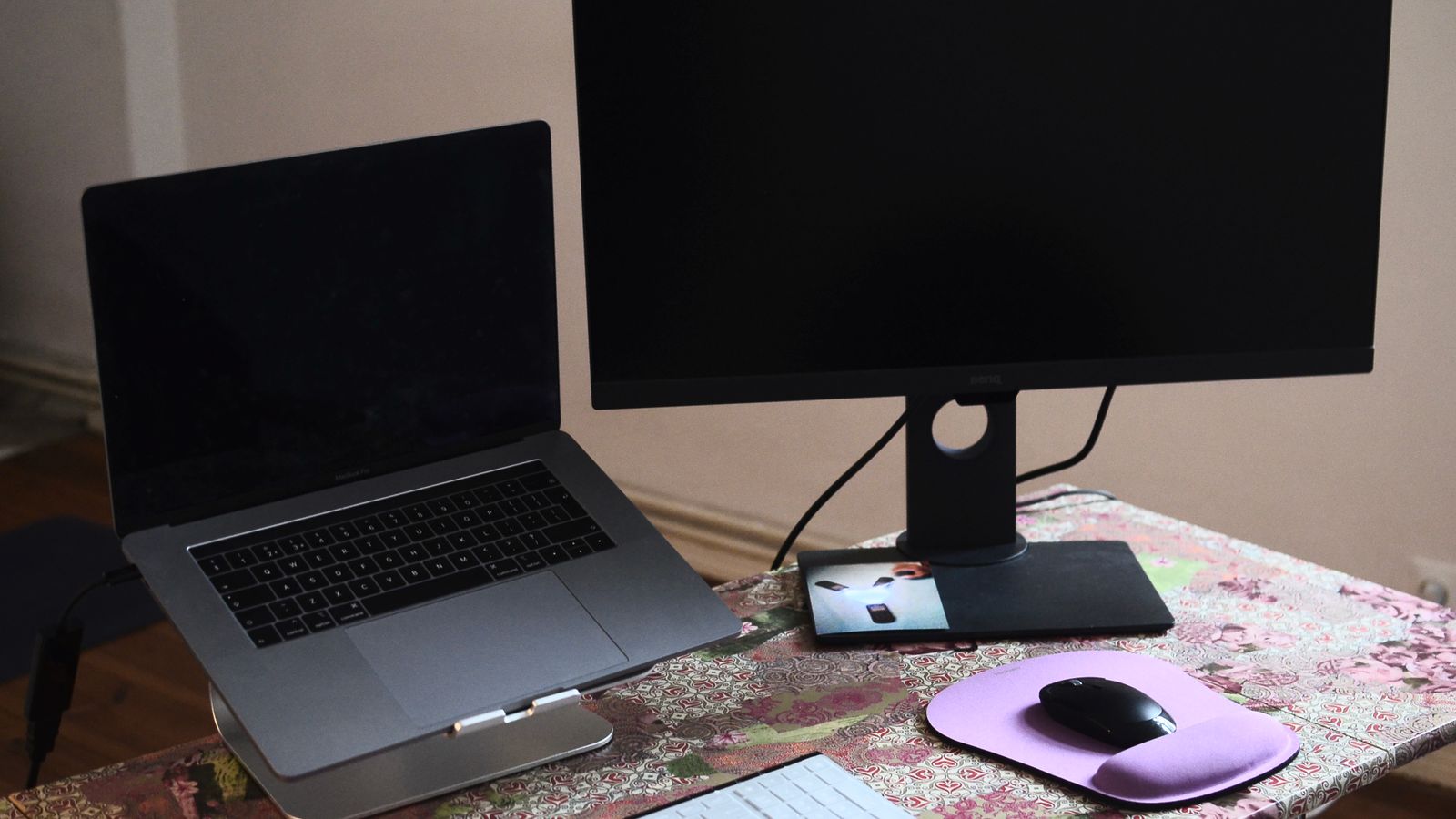 External monitor and keyboard connected to a laptop docking station on a desk