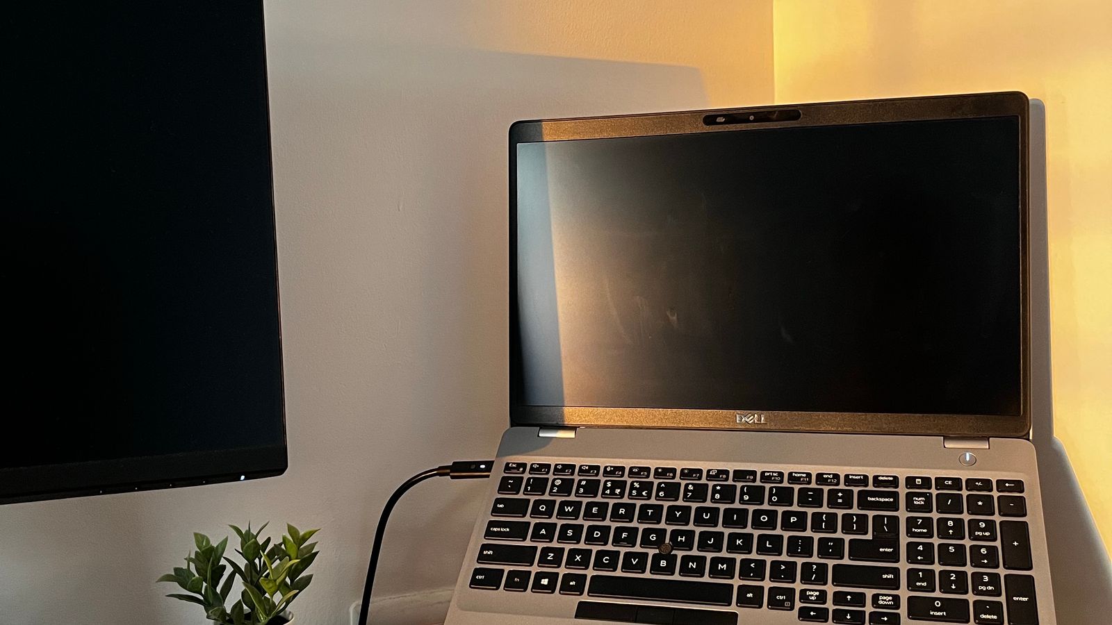 Neatly organized desk setup with laptop stand, external monitor, and cable management
