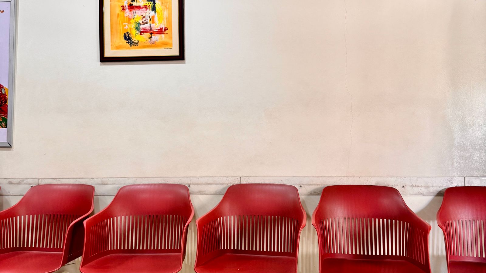 Modern waiting room with a row of reception chairs for visitors