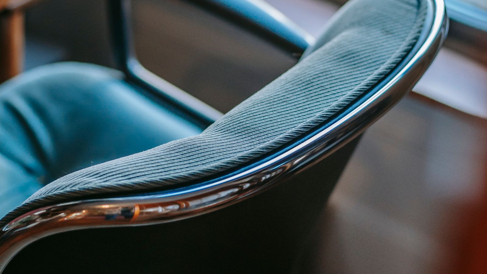 Person adjusting the straps under an office chair seat extender for a secure fit