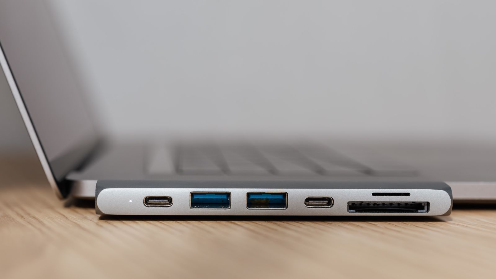 USB-C hub connected to a laptop with multiple cables organized on a desk