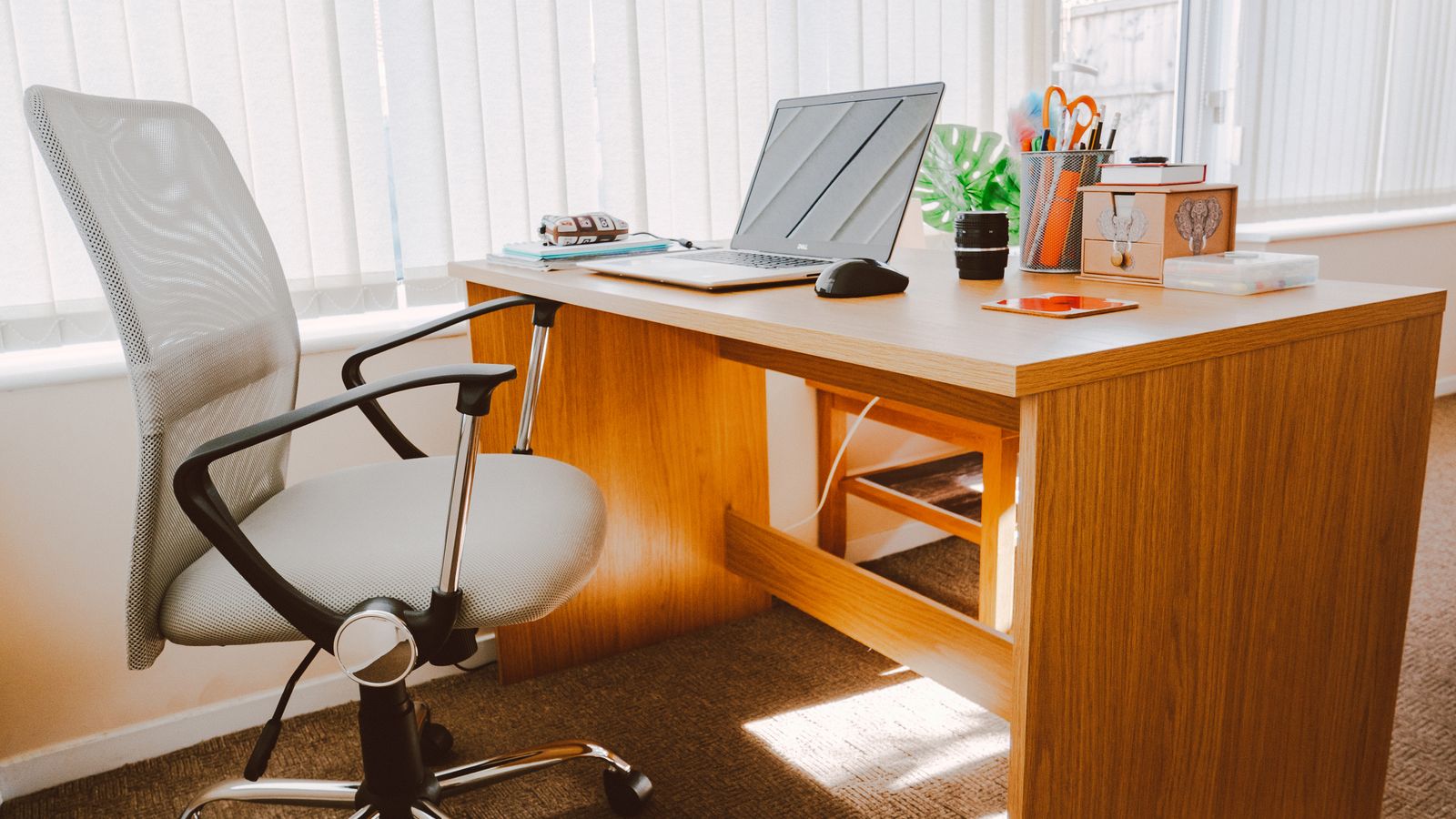 Anti-fatigue mat and footrest positioned next to a short-height standing desk