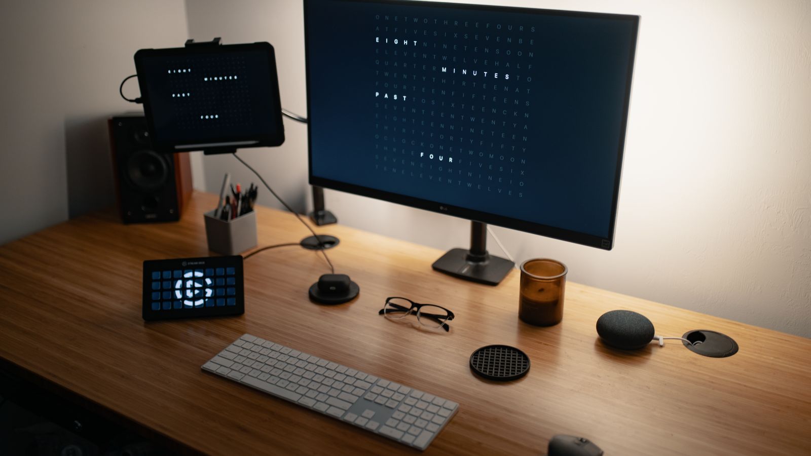 Tablet secured in a desk mount clamp on a home office workstation
