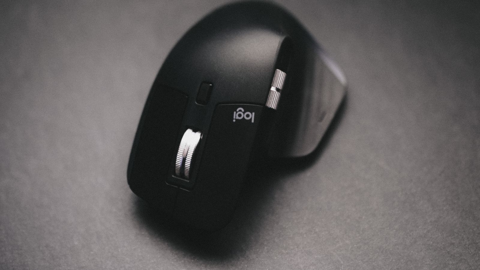 Hand using the thumb ball and buttons on an ergonomic trackball mouse
