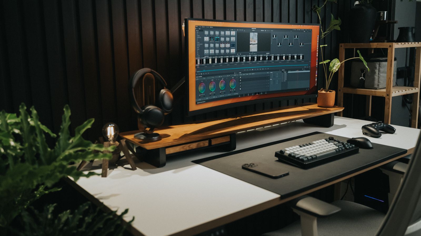 Ultrawide monitor mounted on an articulating arm above a modern desk setup