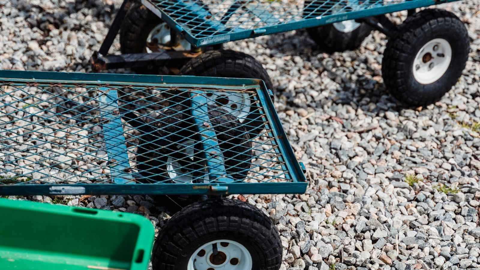 Slim three-tier utility cart with wheels positioned in a small apartment kitchen