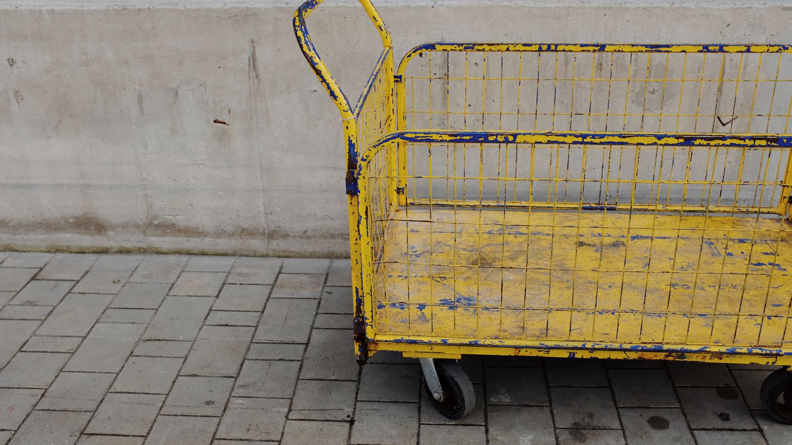 Person organizing office supplies on a multi-tier rolling storage cart
