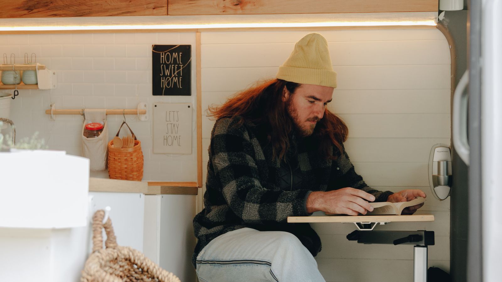Compact fold-down desk mounted inside a converted camper van